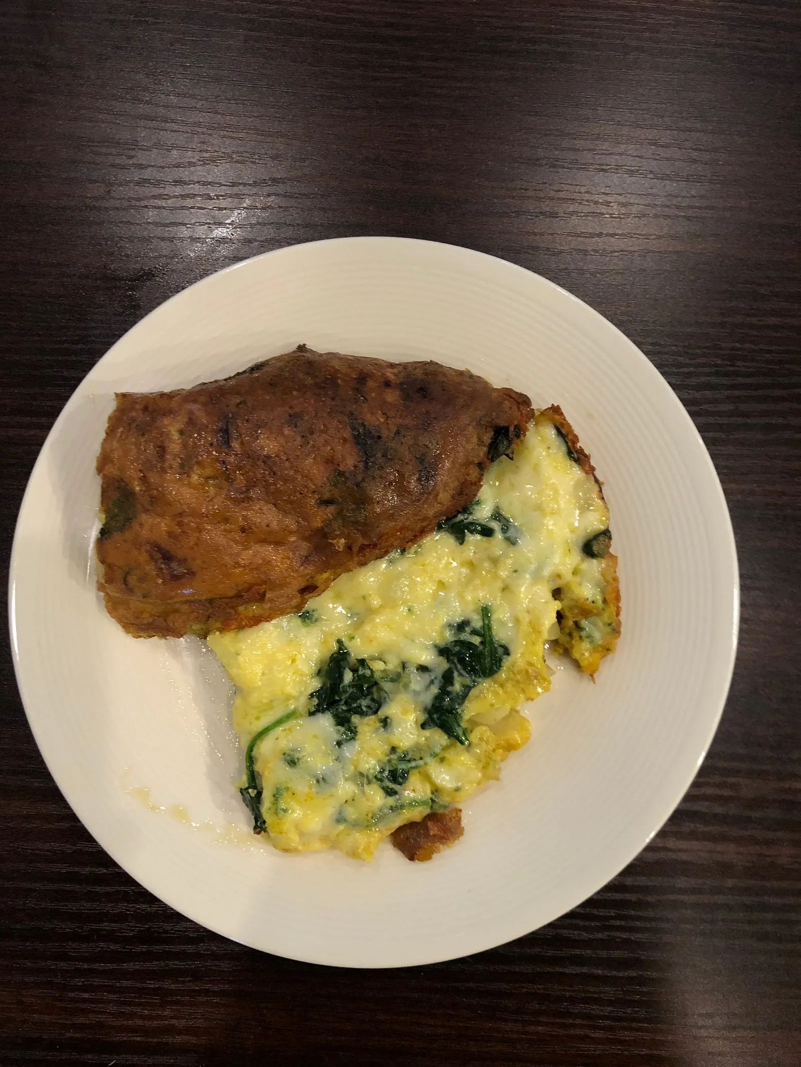 Egg omelette with spinach, green pepper, onions and cheddar cheese.